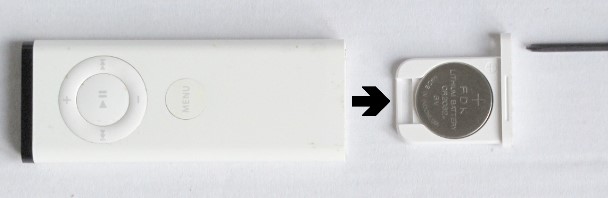 Use a pin to open the Apple Remote battery tray